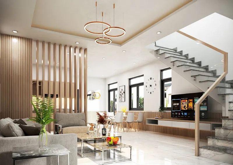 Góc đọc sách ấm cúng dưới gầm cầu thang với ghế bành, đèn và kệ sách nhỏ
